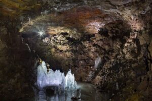 Inside the Lofthellir lava tube with ancient ice formations